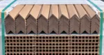 Composite L-angle trims stacked on a pallet above decking boards
