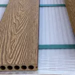 Teak composite decking board — close-up of the wood grain and hollow core